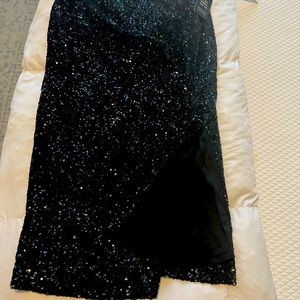 Black sequin skirt.  MIDI length with side slit.  Size small.